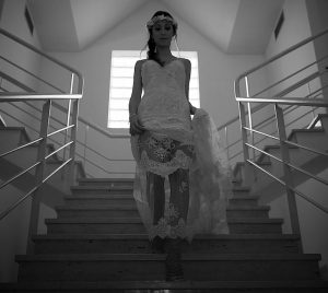 bride with her white wedding dress on the stairs